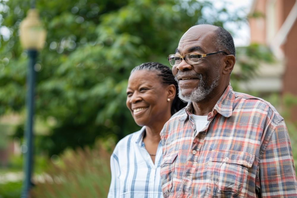 Happy African American woman walks with her senior father glasses adult happy.