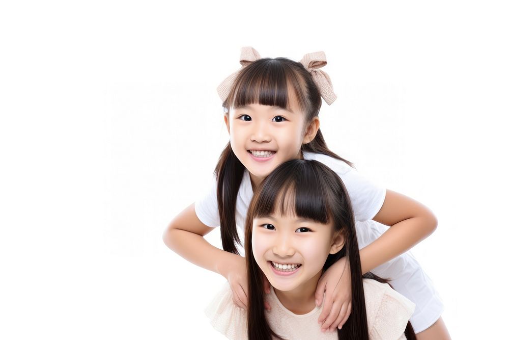Asian girl piggybacking her sister family smile white background.