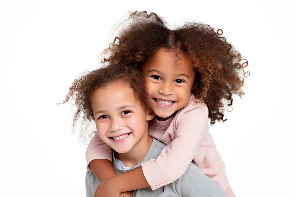 Mixed race girl piggybacking her sister portrait child smile.
