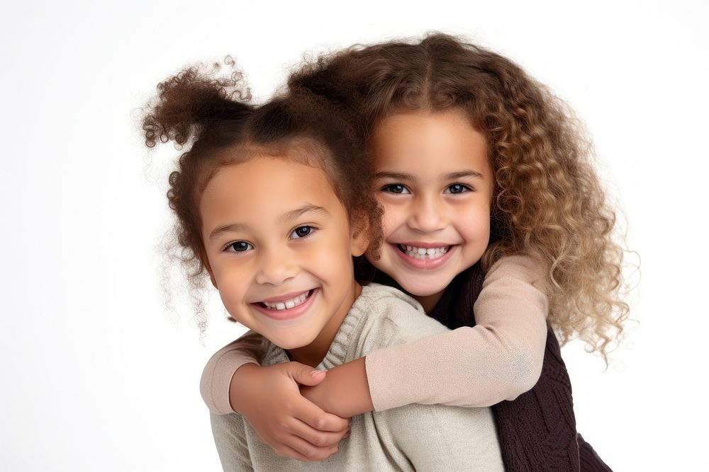 Mixed race girl piggybacking her sister laughing portrait child.