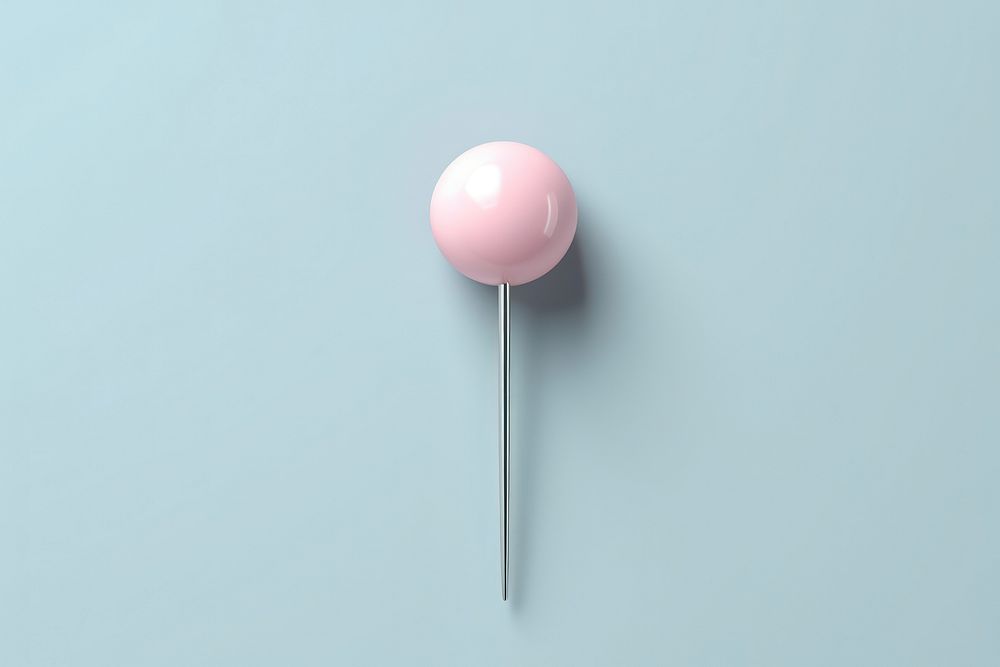 Drawing pin balloon confectionery lollipop.