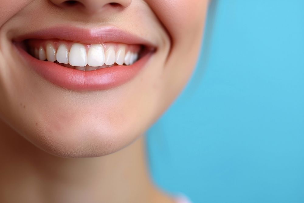 Girl showing beautiful white smile teeth skin blue.