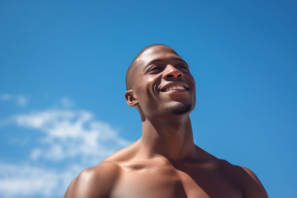 African American fit men deep breathing and smiling adult blue sky.