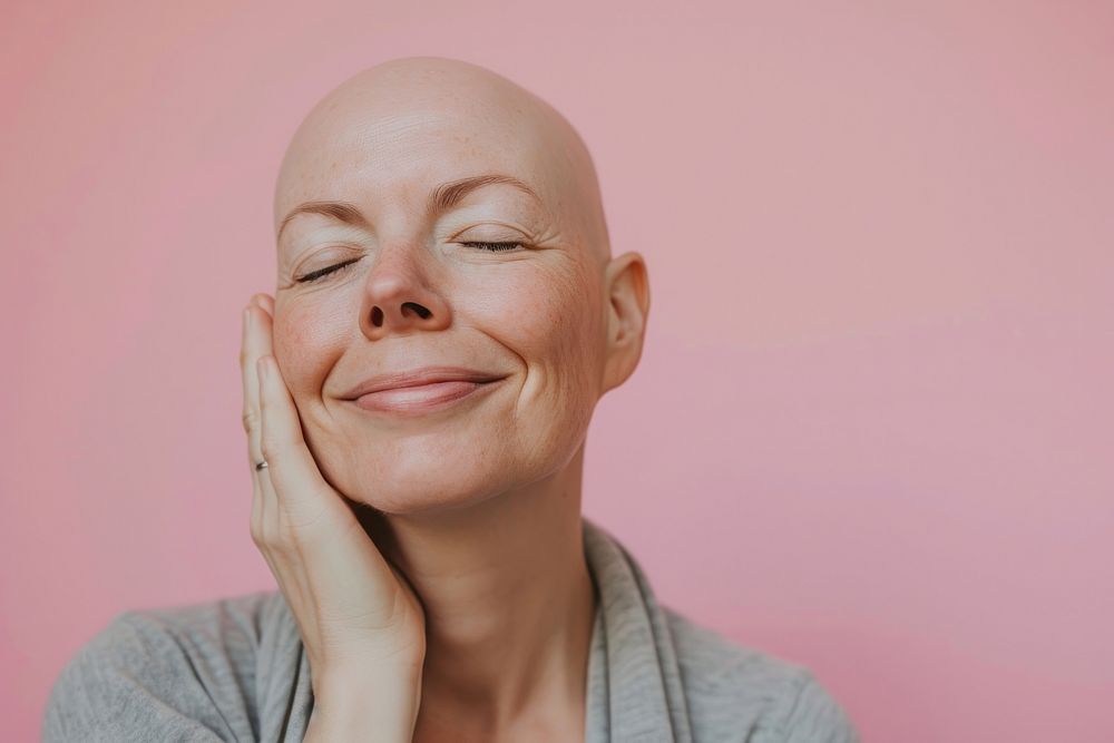 Bald middle age woman touching shaved head smile adult skin.