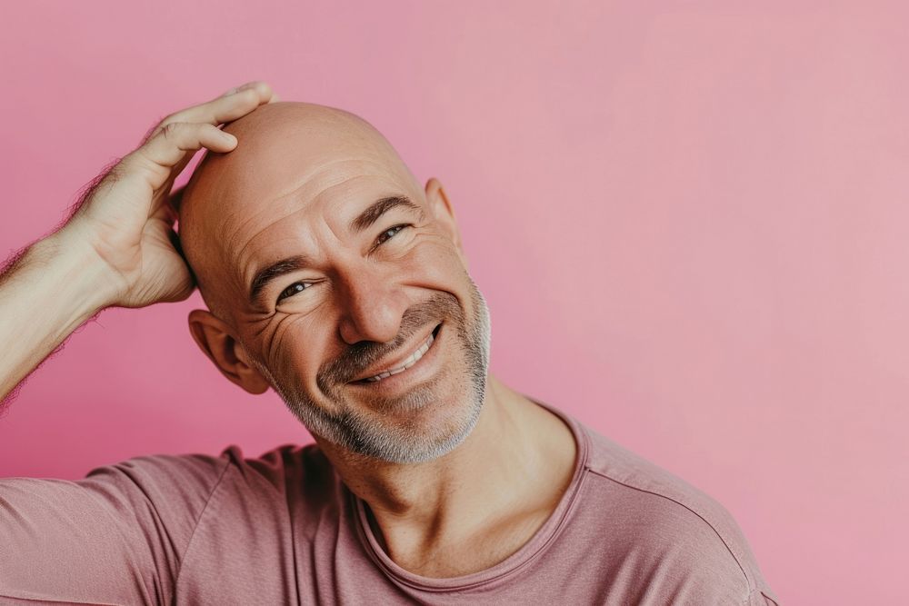 Bald middle age man touching shaved head smile adult men.