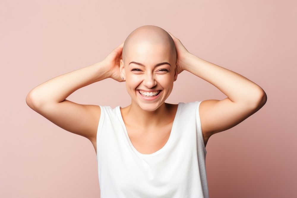 Bald woman touching shaved head smile adult relaxation.