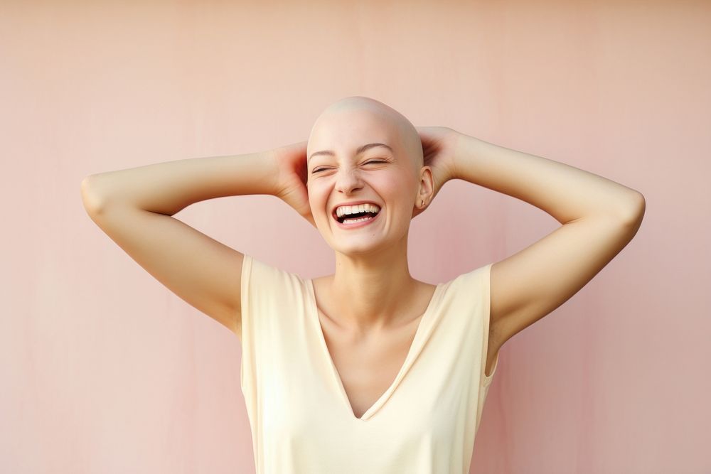 Bald woman touching shaved head smile laughing adult.