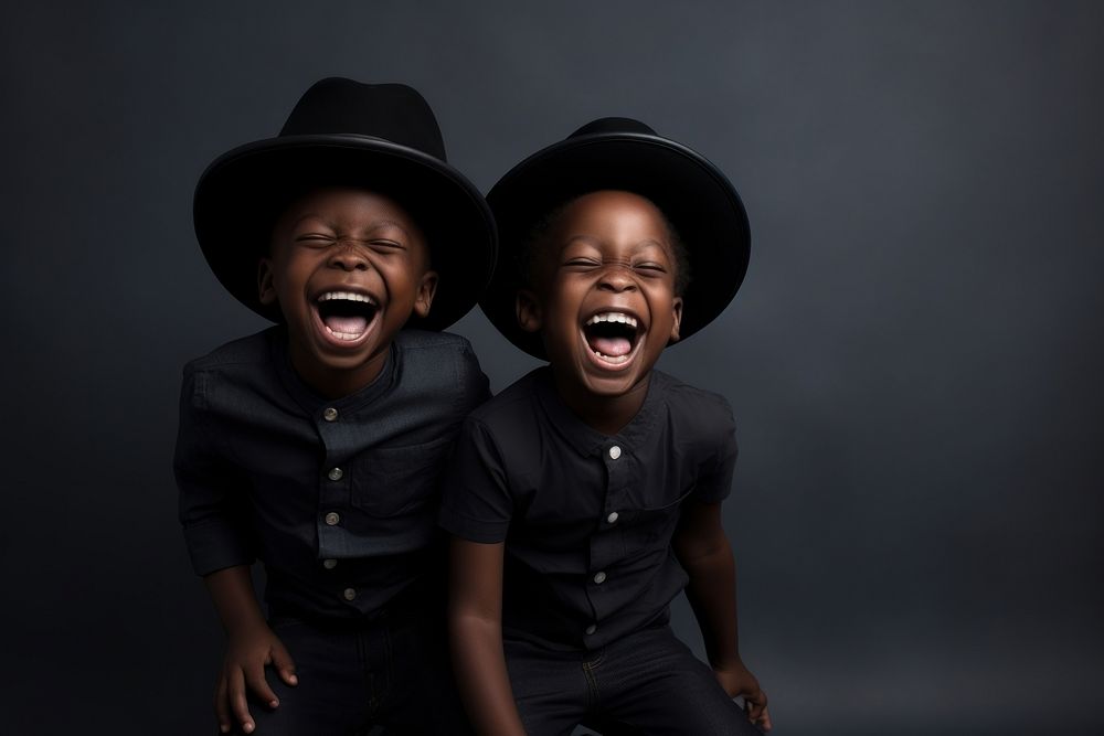 Happy black boys playing laughing shouting togetherness.