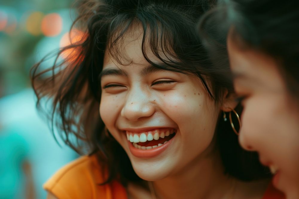 Thai girl laughing with her friend smile togetherness affectionate.