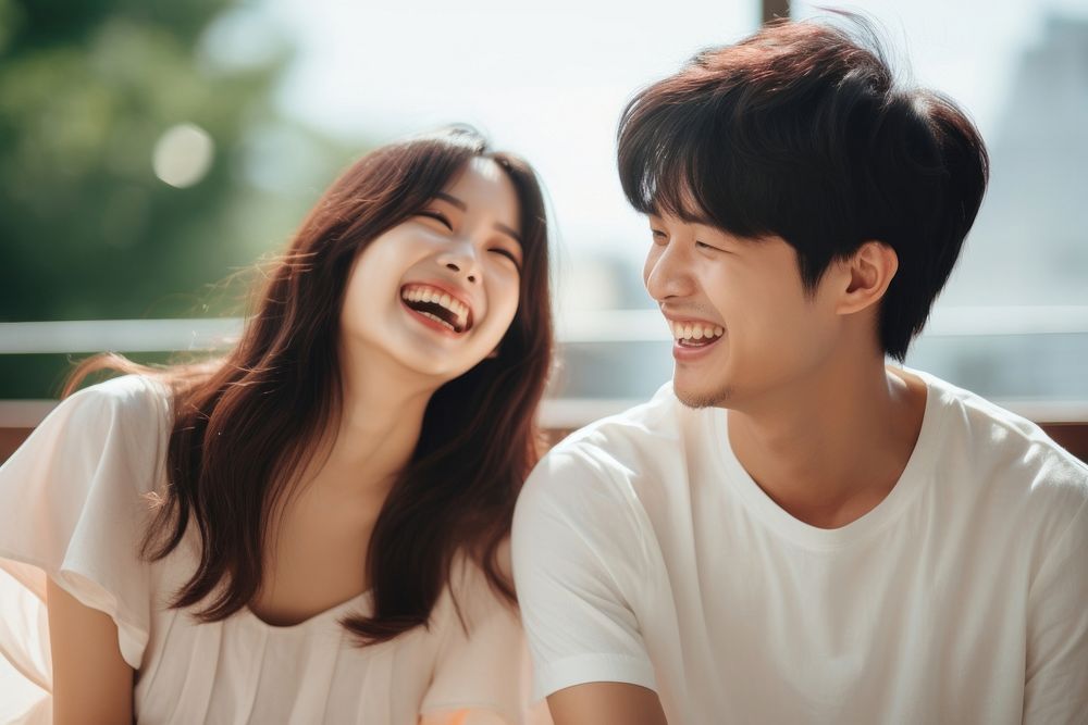 Korean girl laughing with her couple smile togetherness affectionate.