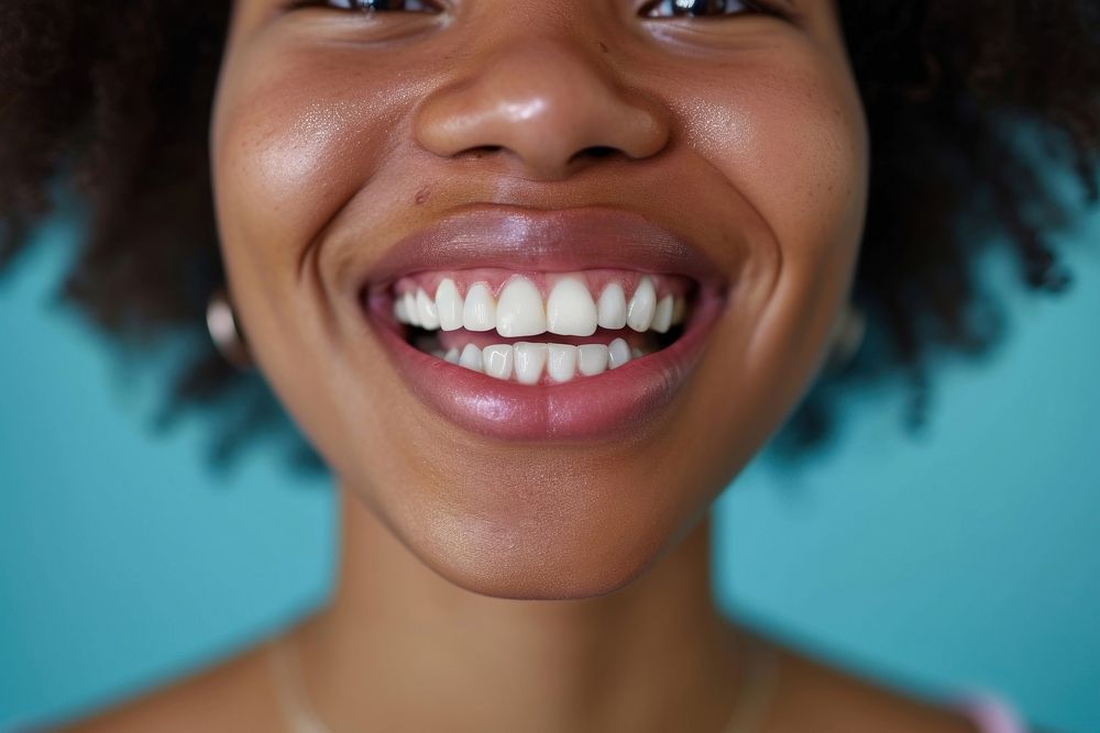 African American woman showing smile on camera teeth skin hairstyle.