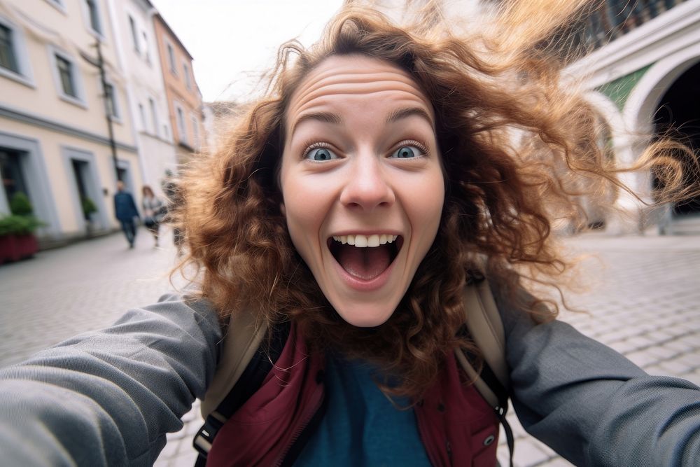 Woman excited face portrait selfie laughing.