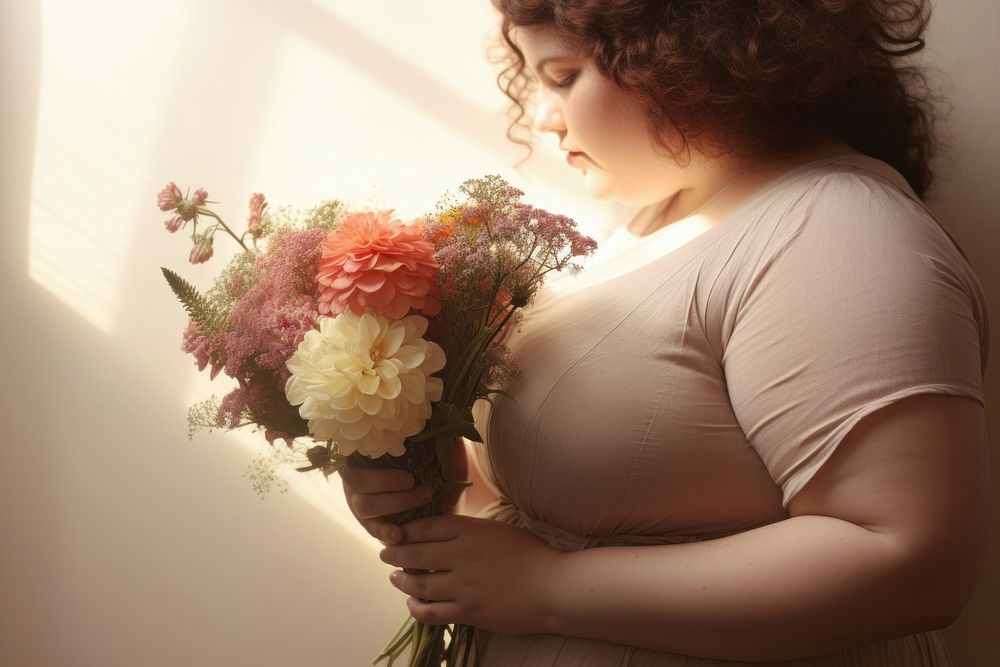 Chubby body woman holding flowers portrait adult photo.