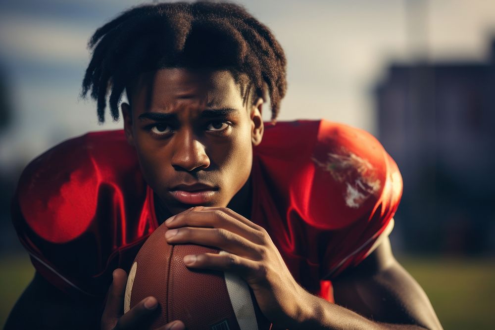 Black teen enjoy playing american football on field sports determination competition.
