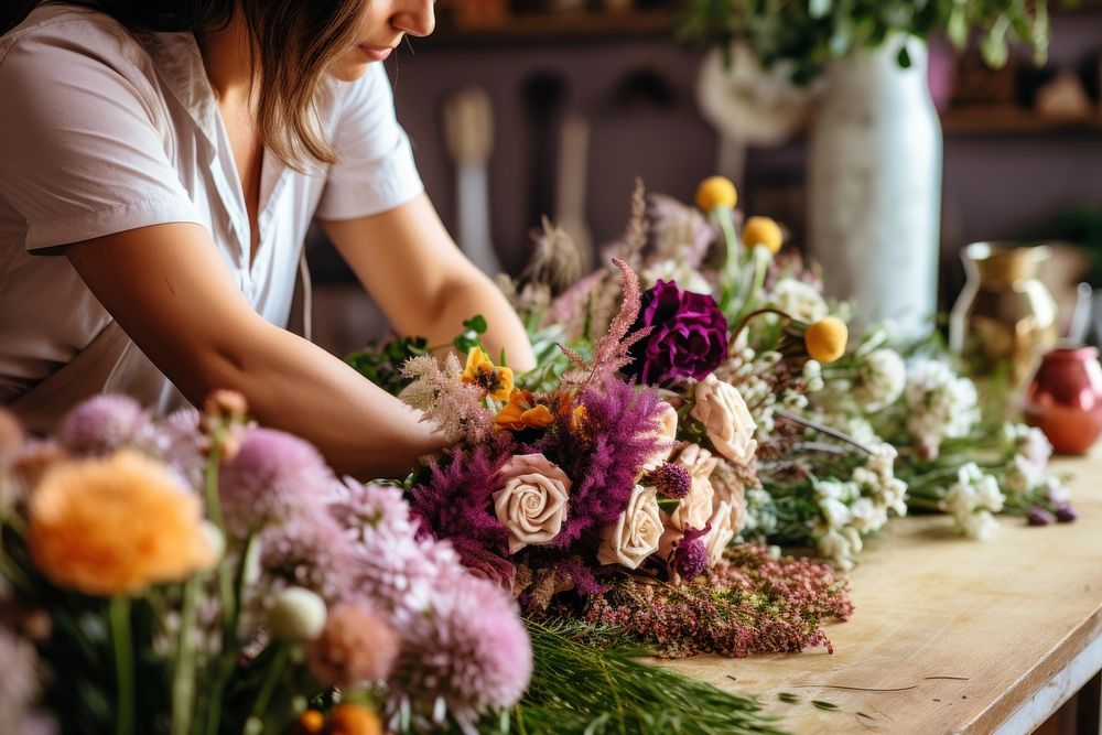 Florist creating feneral bouquet flower craft plant.