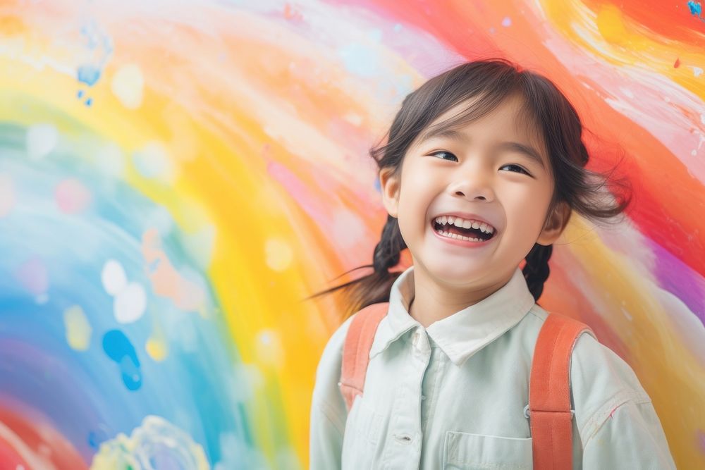 Little girl is painting the colorful laughing portrait child.