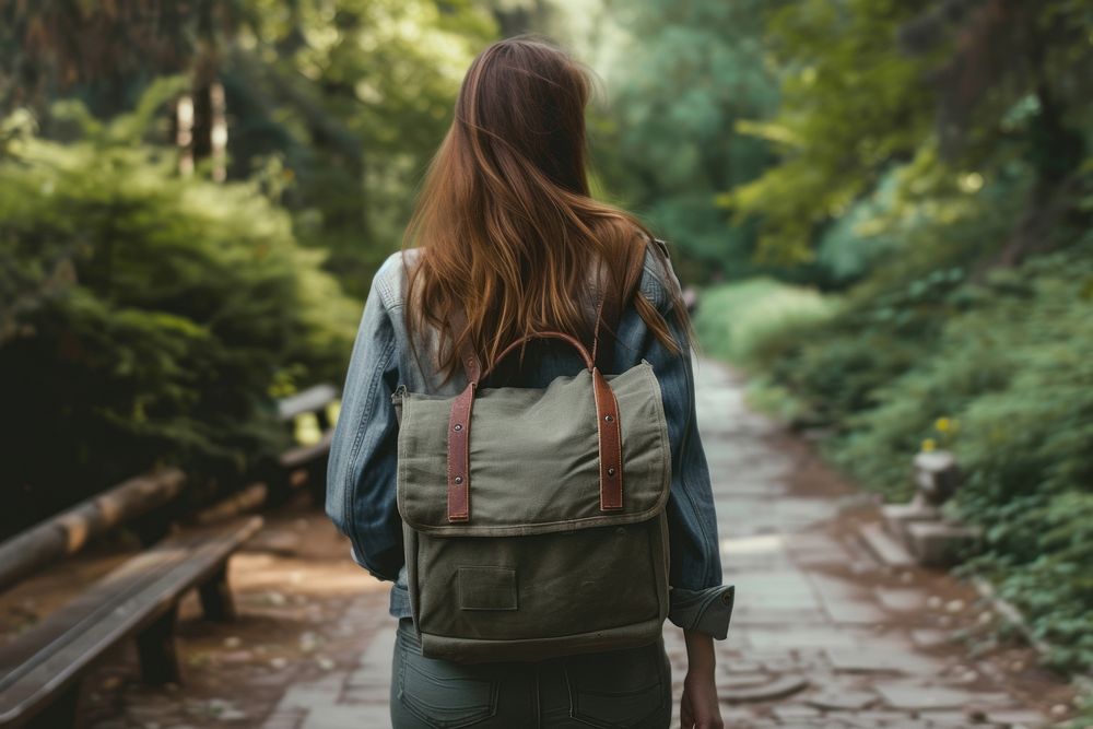 Woman with canvas bag backpack outdoors walking.