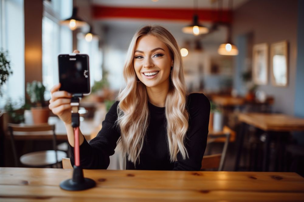 Woman influencer vlogging selfie smile photo.