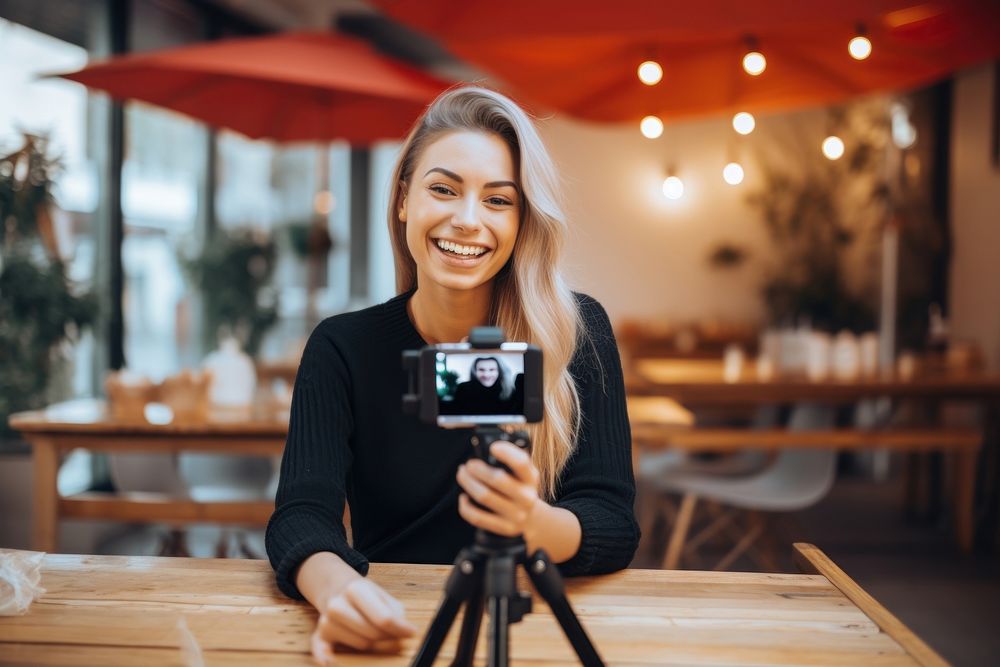 Woman influencer vlogging selfie smile photo.