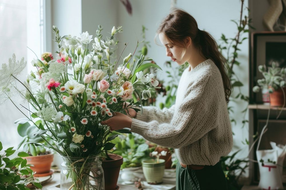 Women make flower arrangement plant adult concentration.