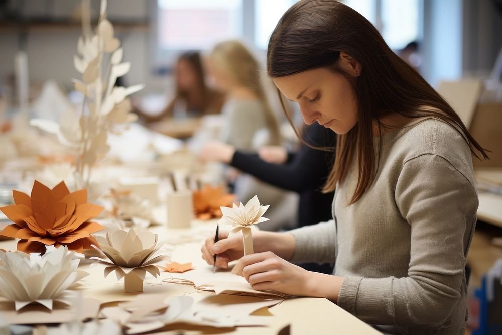 Paper craft workshop women concentration.