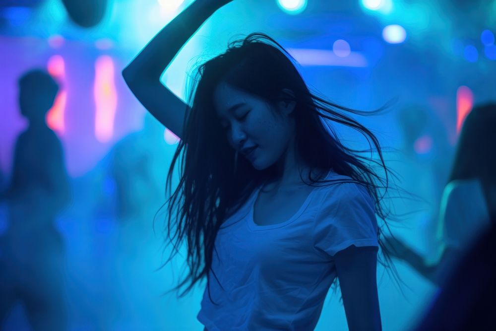 Asian woman dancing disco nightclub.