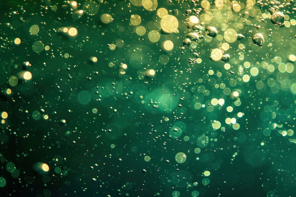 Bubbles and bokeh underwater in clear green ocean outdoors glitter nature.