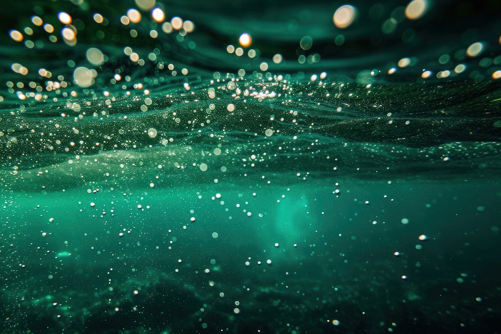 Bubbles and bokeh underwater in clear green ocean sea outdoors nature.