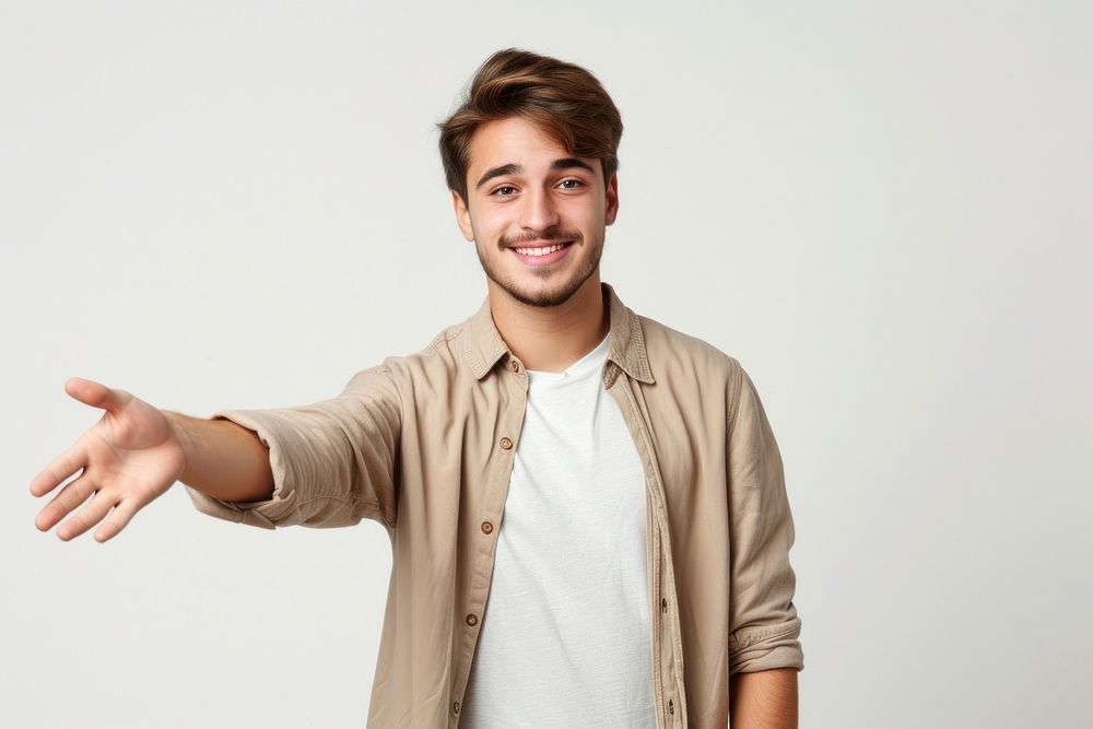 Young handsome caucasian man over isolated background extending hands to the side for inviting to come portrait adult smile.