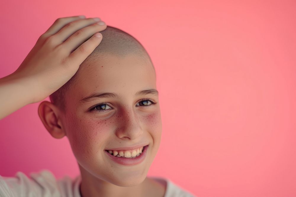 13 year old boy touching shaved head smile skin hairstyle.