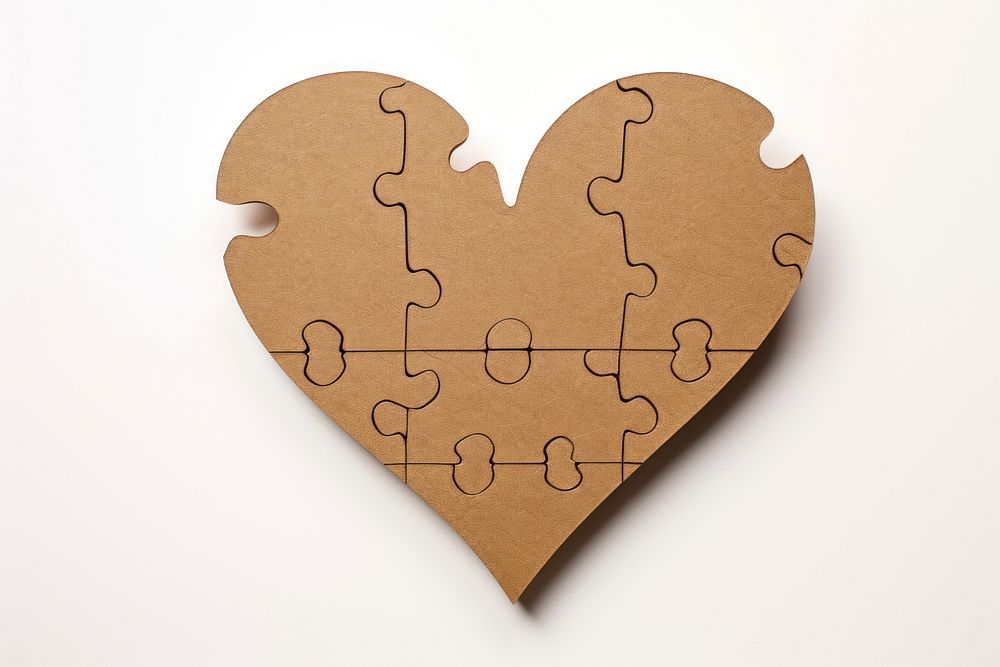 2d jigsaw heart symbol made of cardboard paper creativity solution strategy.
