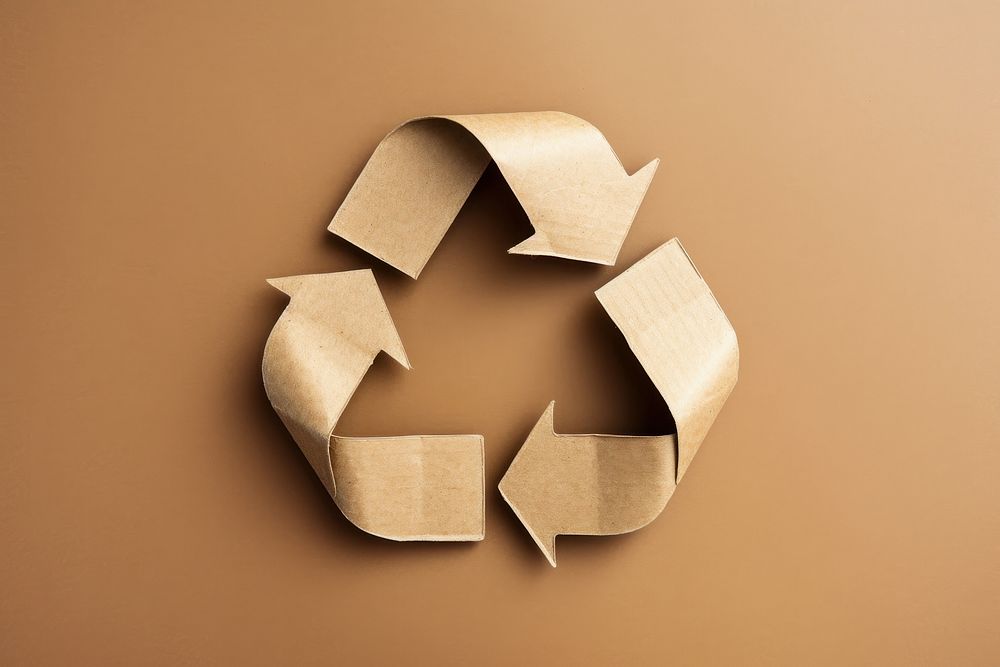 Recycle symbol made of cardboard paper recycling circle yellow.