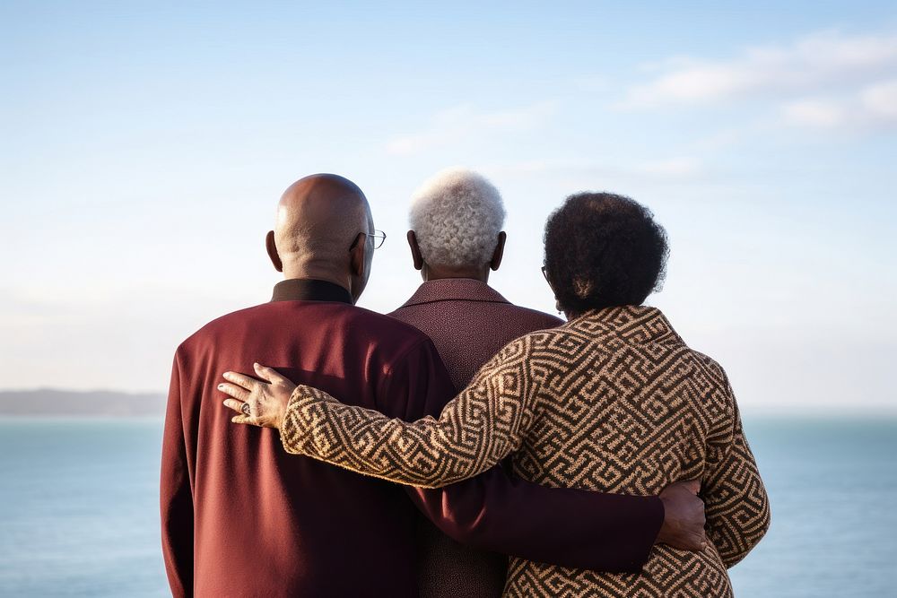 3 friends african-american elderly hugging adult back.
