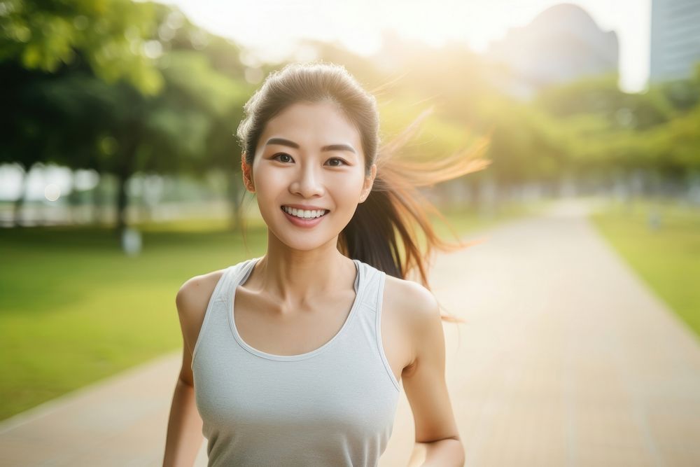 An beautiful asian athlete taking selfie while jogging in public park smile architecture exercising.