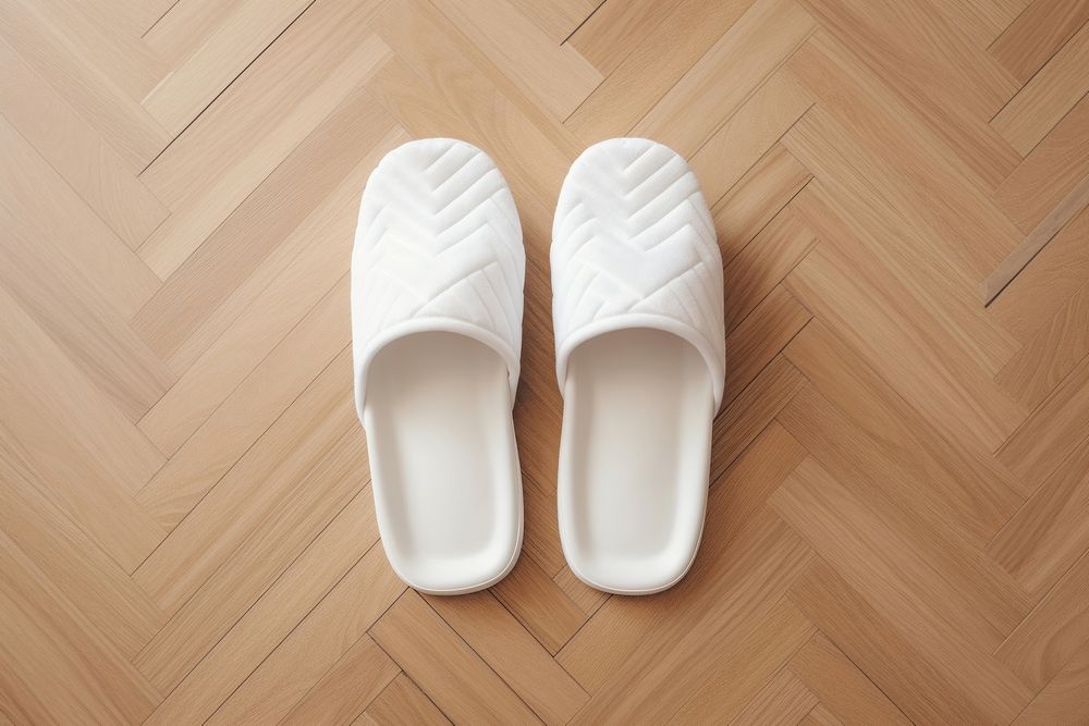 Blank white cotton terry slippers put on parquet floor footwear shoe flip-flops.