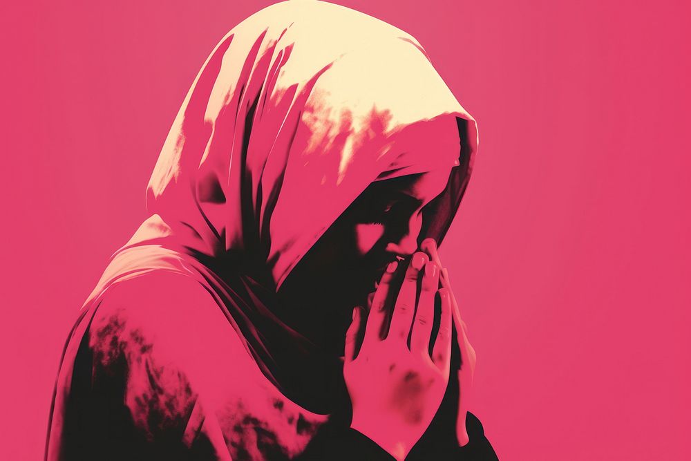 Muslim girl is praying pink red headscarf.