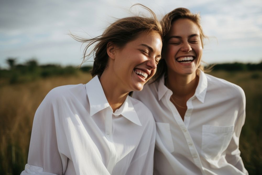 2 women wearing white fabric apron laughing outdoors adult.