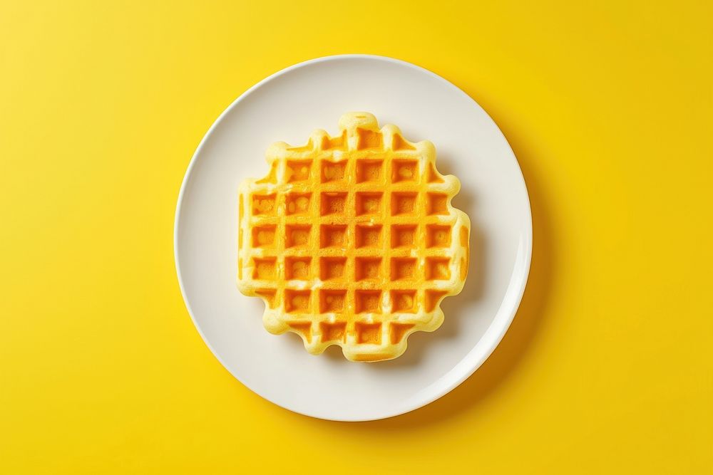 Waffle on a white plate yellow food yellow background.