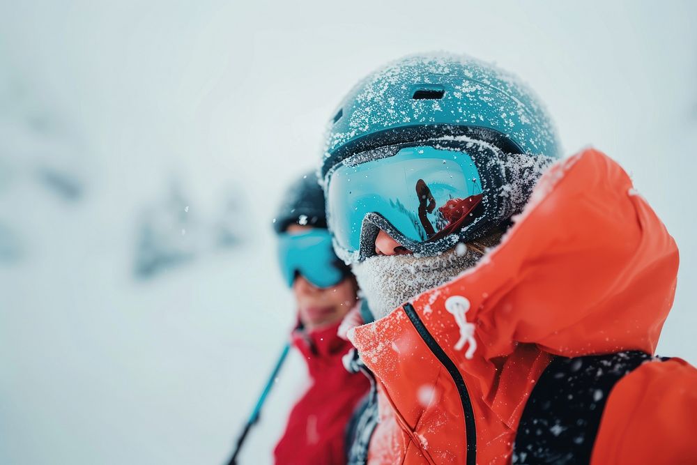 Couple skiing on mountain outdoors recreation helmet.