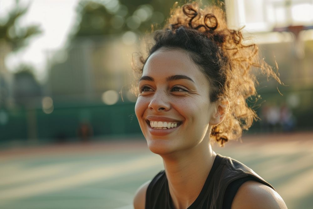 Mid adult woman playing basketball smile happy exercising.