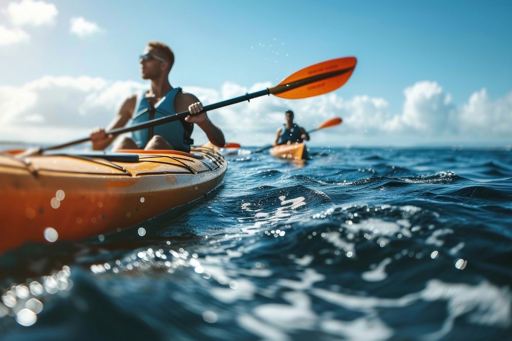 Two men paddle a kayak on the sea kayaking recreation lifejacket.