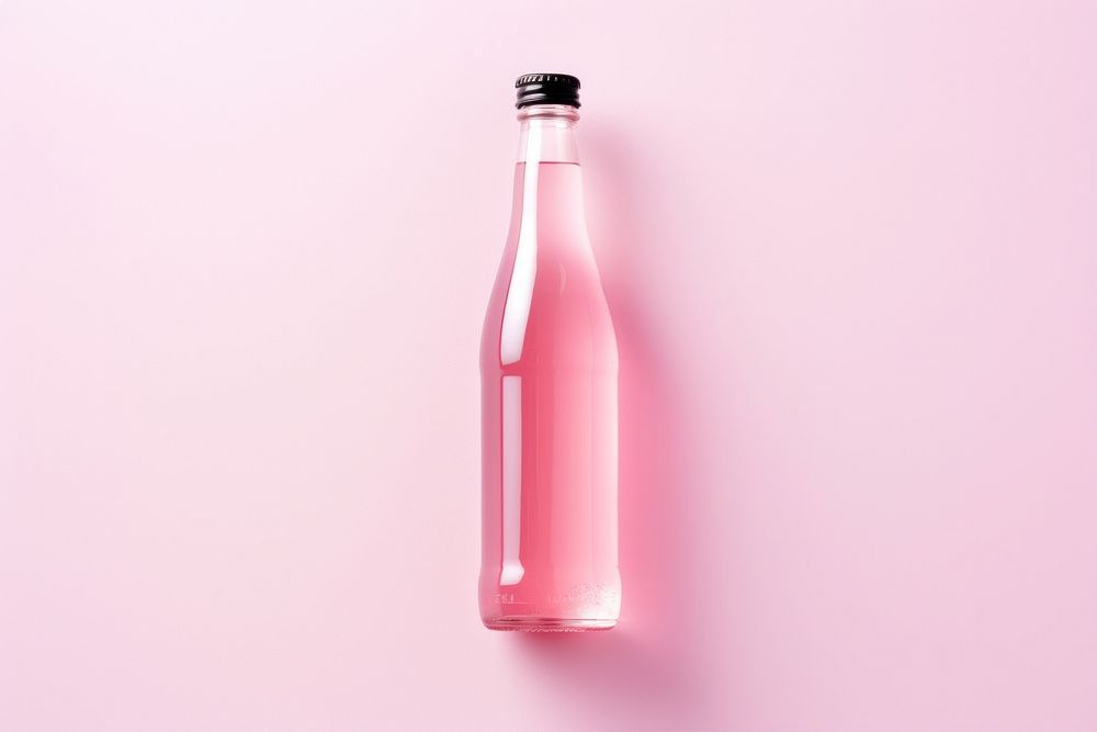 Soda bottle with white lable drink pink pink background.