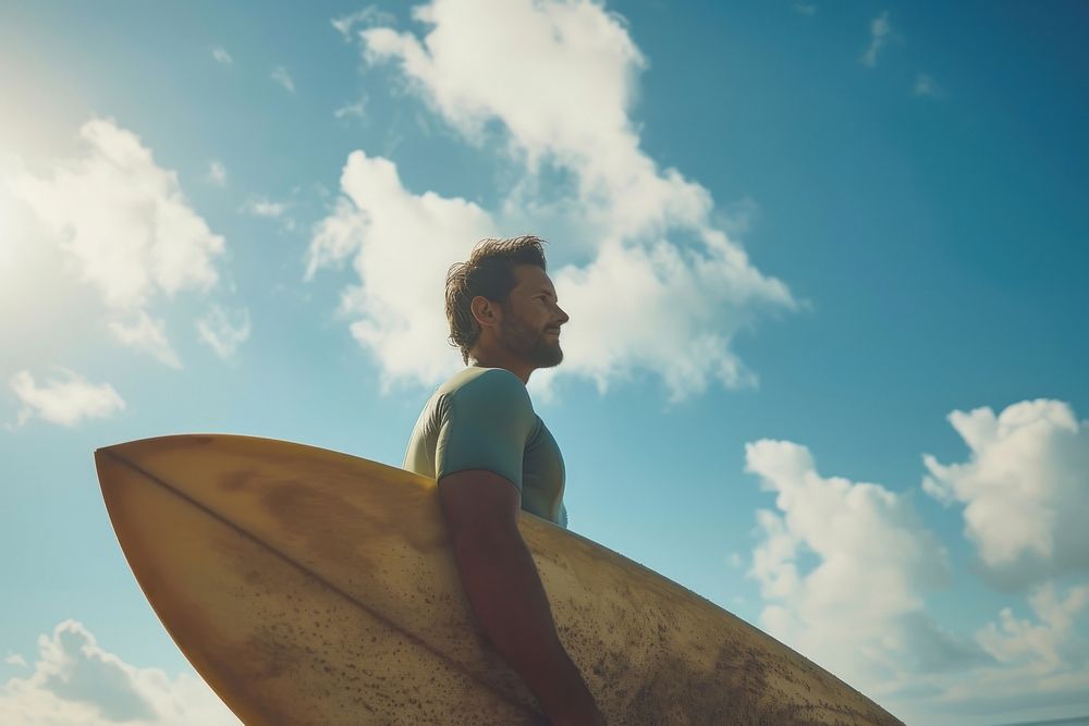 Man holding surfboard outdoors surfing nature.