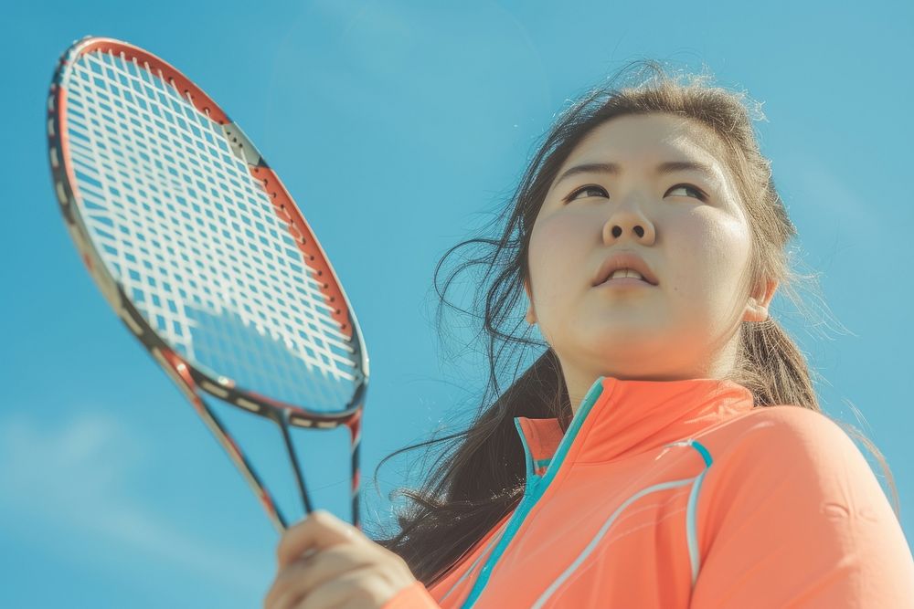 Asian woman holding badminton racket sports outdoors tennis.