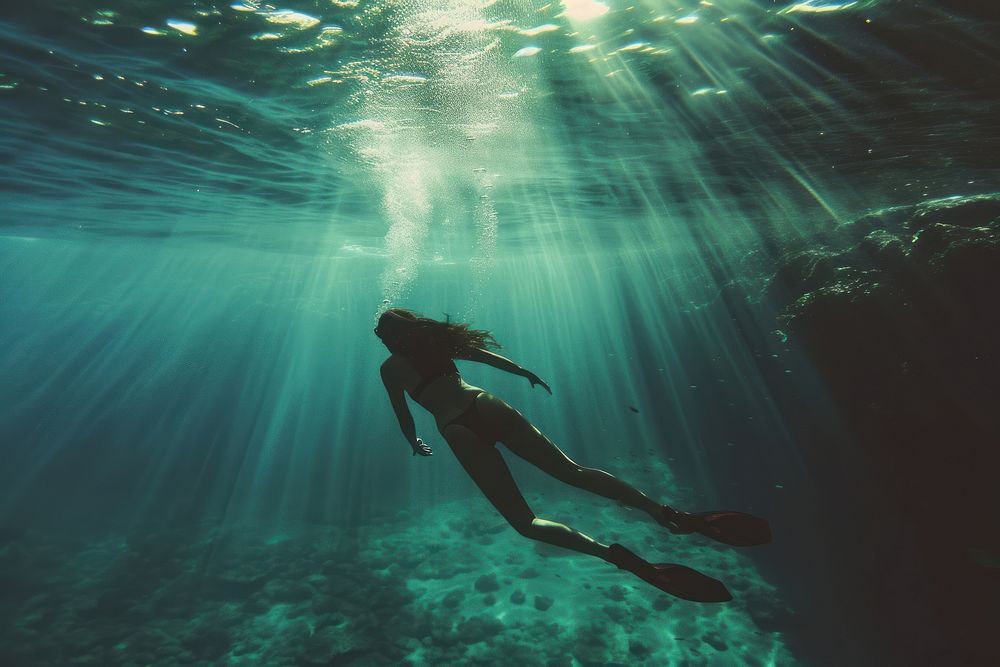 Woman diving underwater outdoors adventure swimming.