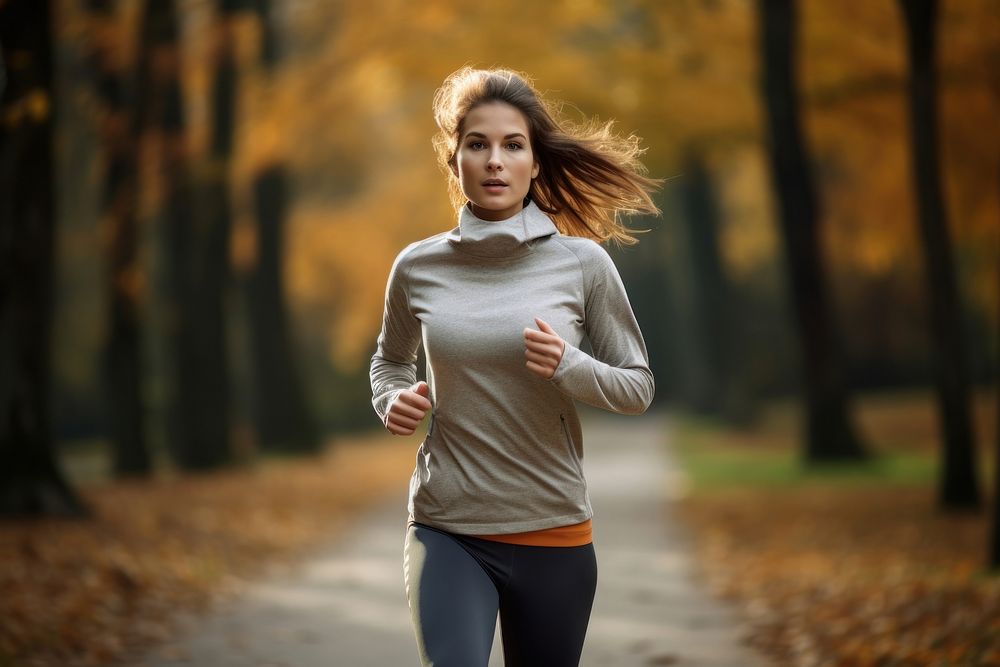 Woman in sport wear running in park outdoors jogging sports.