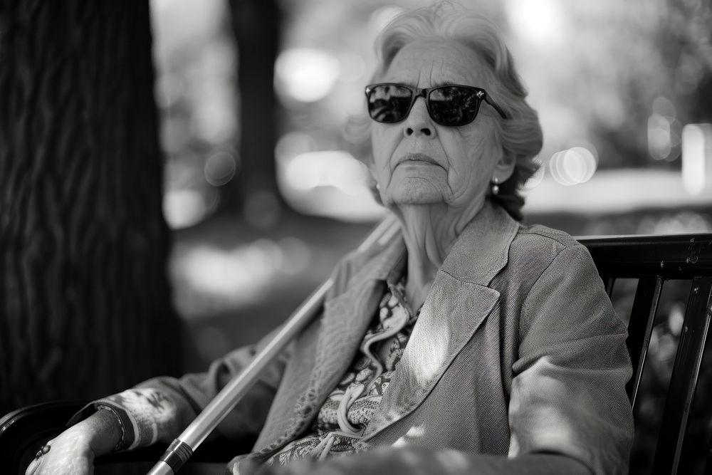 A blind woman sunglasses portrait sitting.