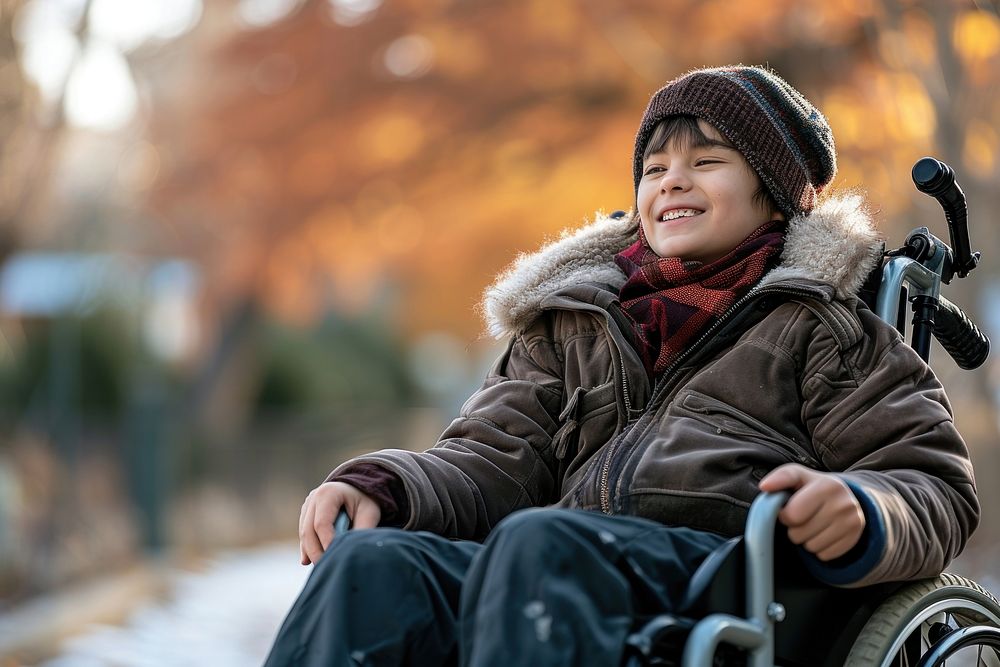 A boy on wheelchair smiling sitting architecture.