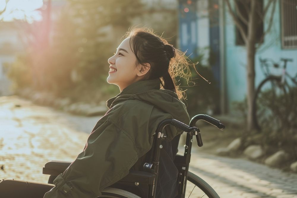 A girl on wheelchair bicycle vehicle smiling.