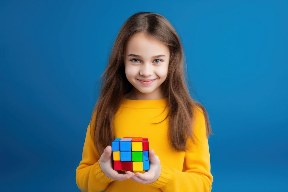 Autistic girl holding a Rubik smile portrait happy.